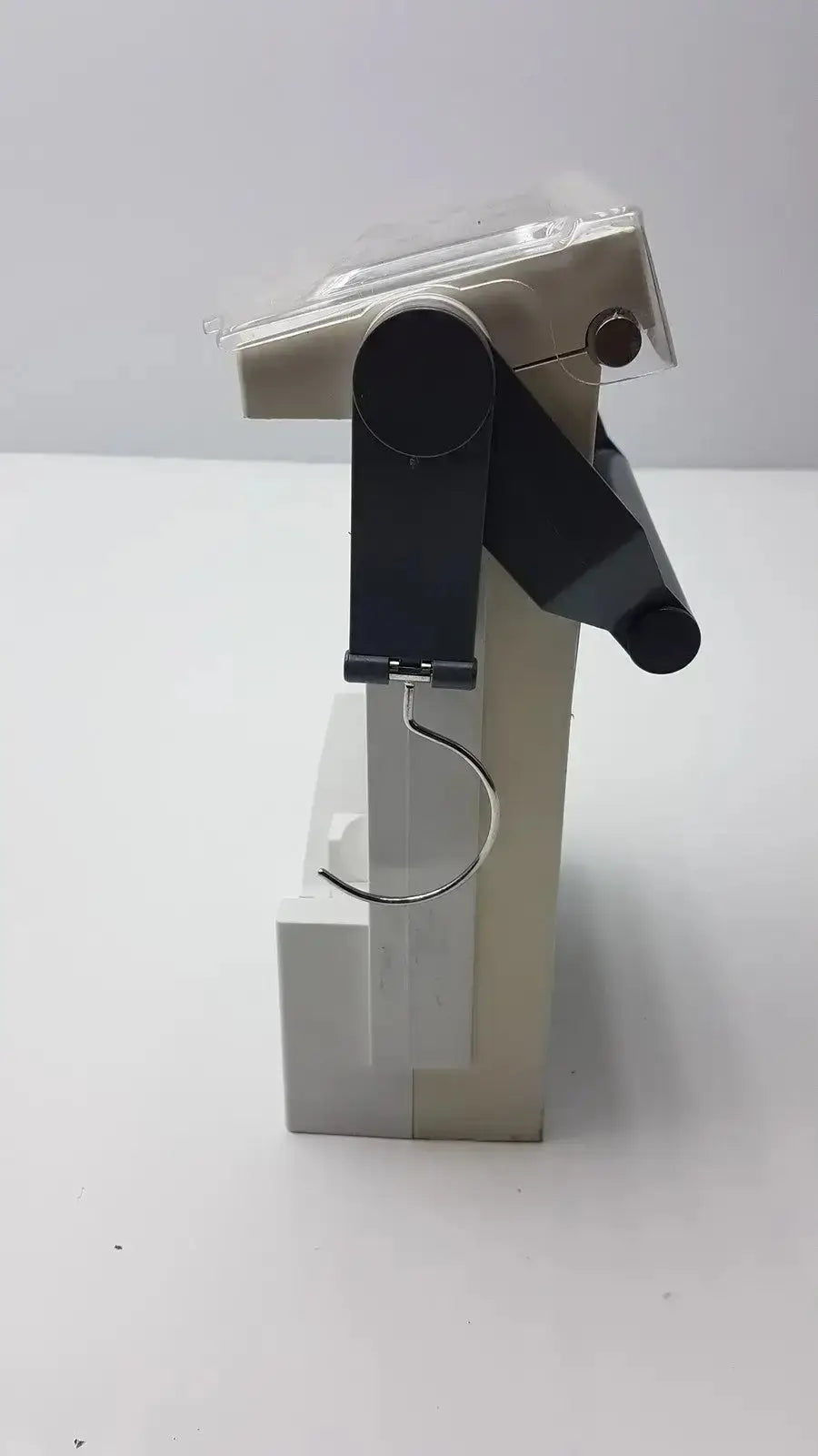 A sleek minimalist white plastic hanger with black metal hook and adjustable arm for bard criticore fluid output temperature monitor 000002n