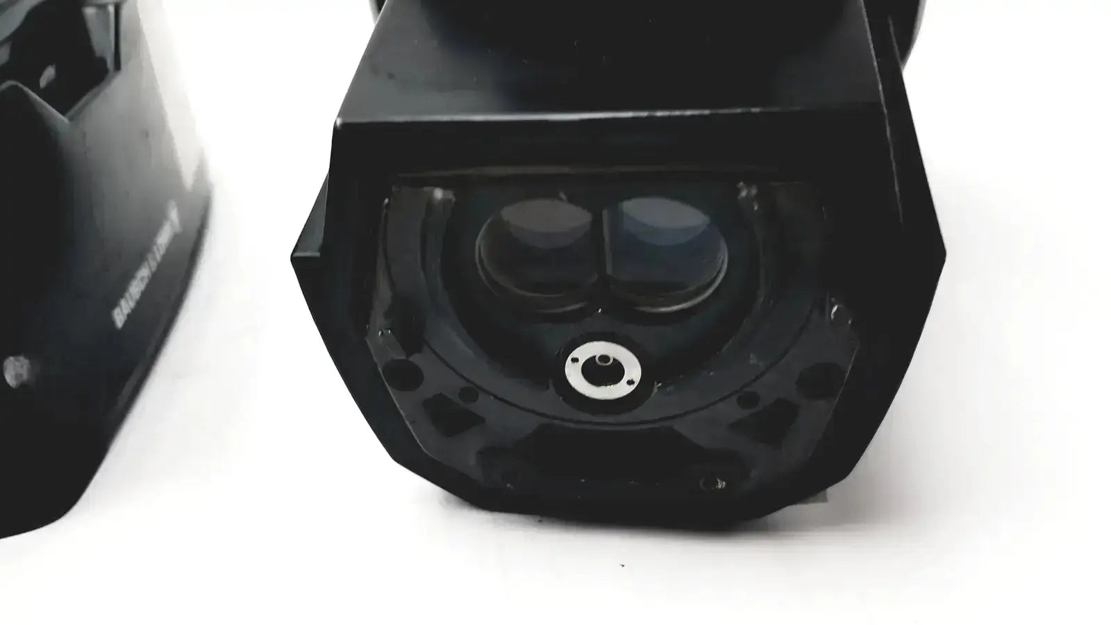 Black cylindrical security camera with dual lenses and central mounting hole for lomb microscope biomedical evaluation hospital surplus