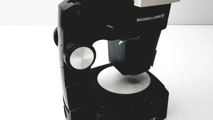 Black bausch & lomb microscope with silver metallic knobs and circular stage for biomedical evaluation hospital surplus