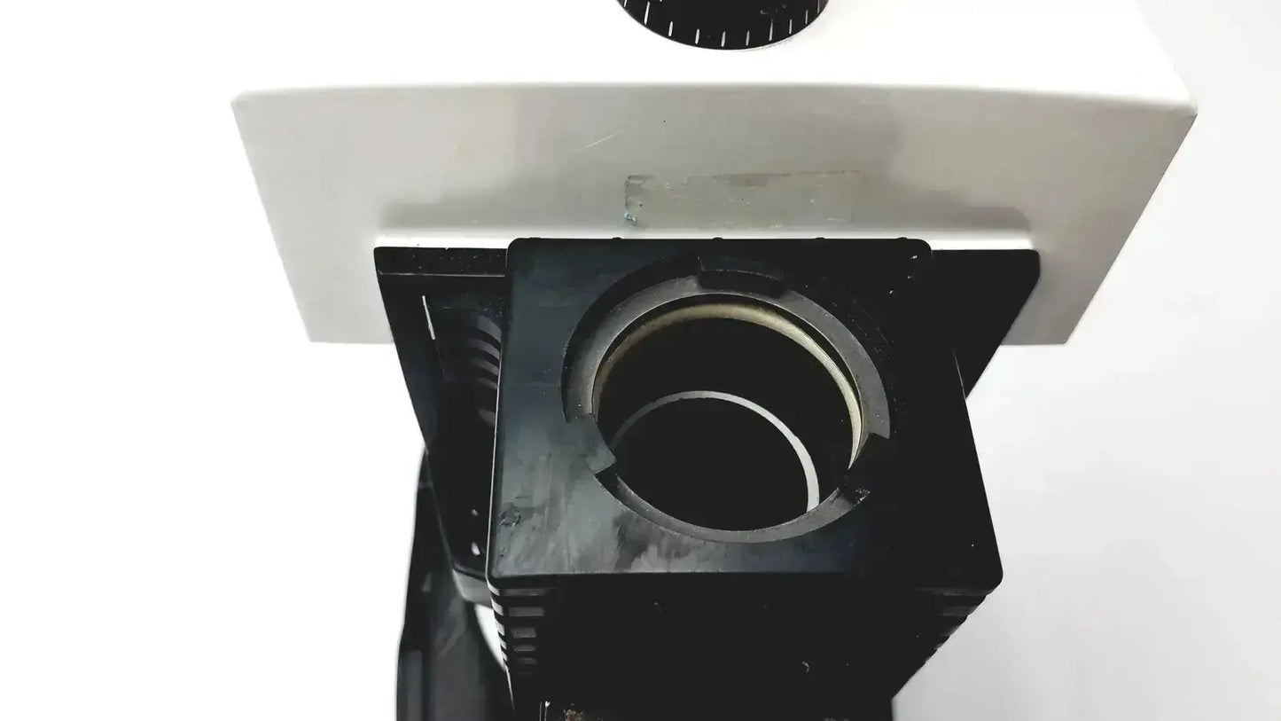 Black stage with circular opening and white body of bausch and lomb microscope for biomedical evaluation hospital surplus