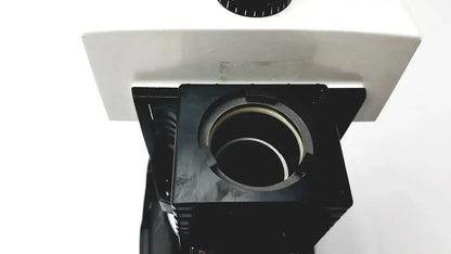 Black stage with circular opening and white body of bausch and lomb microscope for biomedical evaluation hospital surplus