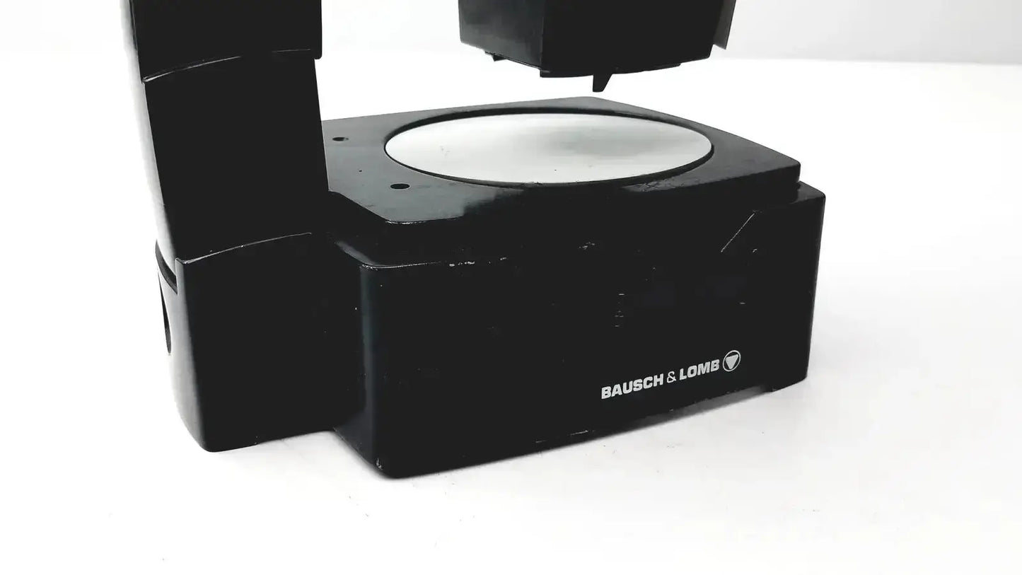 Black bausch and lomb microscope base with circular silver platform and angular design for biomedical evaluation hospital surplus