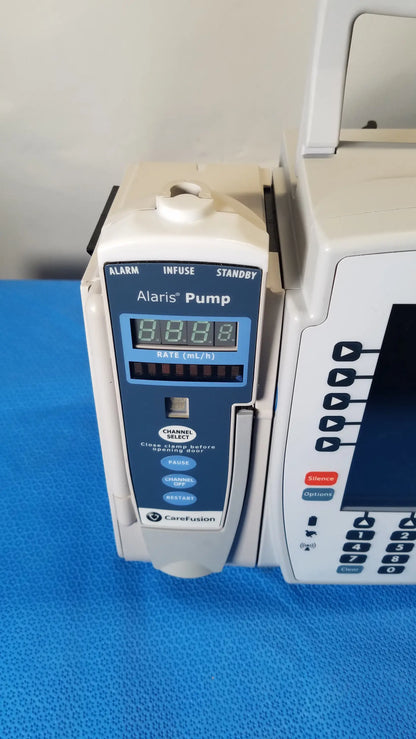 White and blue bd alaris 8015 pc modular infusion pump with digital display showing 8.8.8. for reuse medical equipment