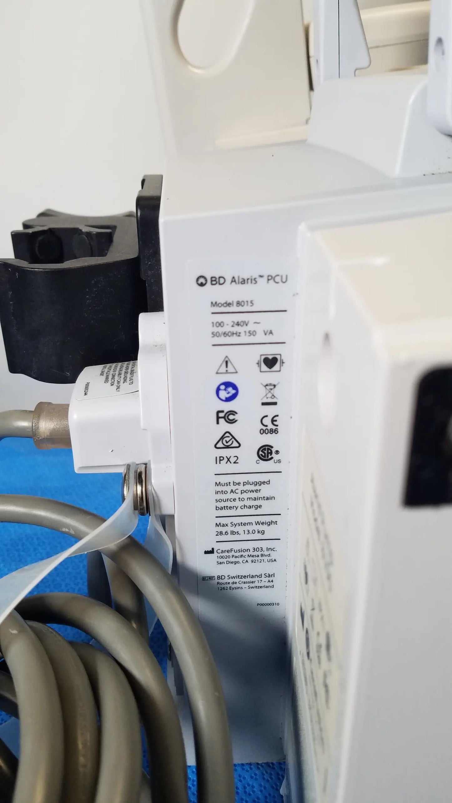 White bd alaris 8015 modular infusion pump with black plastic parts and coiled gray tubing for reuse medical equipment