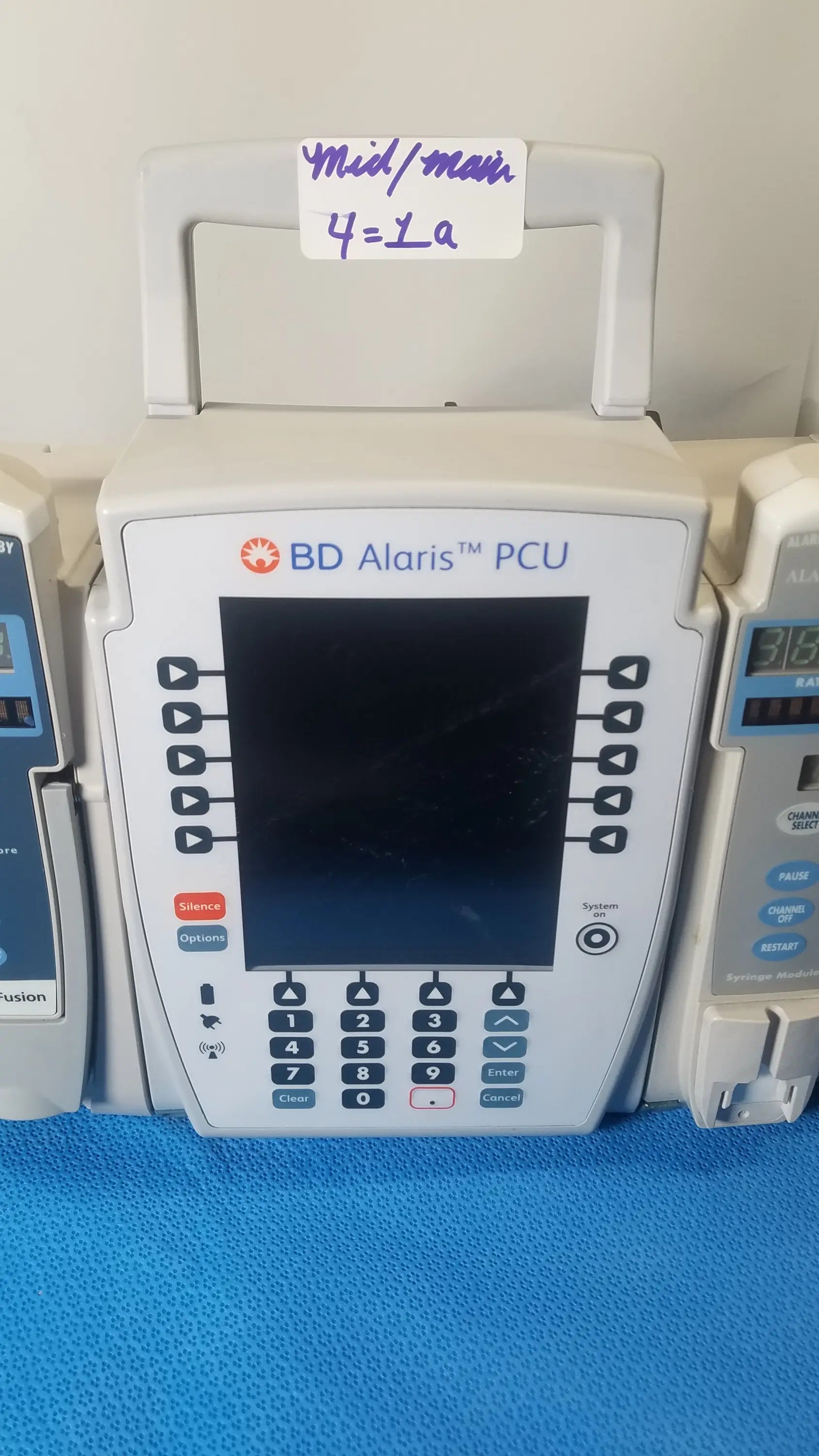 White bd alaris pcu infusion pump with digital screen and control buttons for modular infusion medical equipment reuse