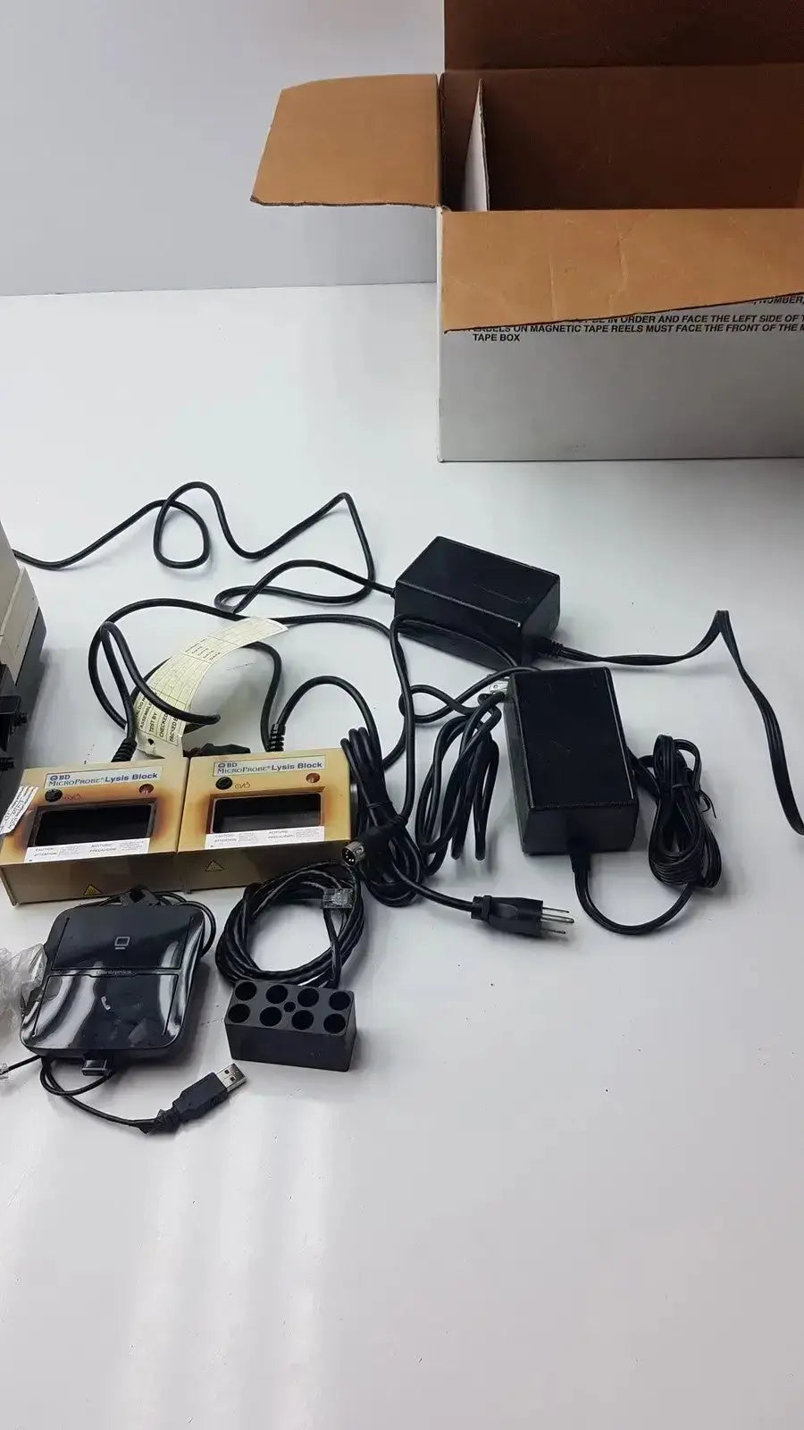 Black plastic power adapters with coiled cords for bd microprobe processor with 2 alysis block used medical equipment for sale