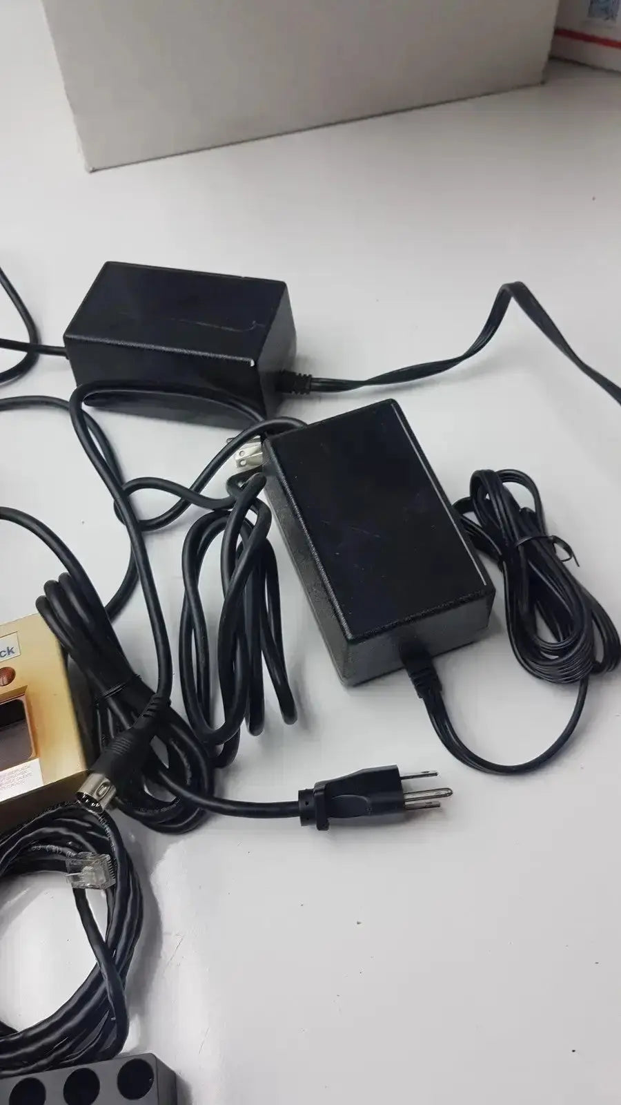 Black plastic power adapters with coiled cords for bd microprobe processor with 2 alysis block pre owned medical equipment for sale