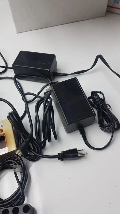 Black plastic power adapters with coiled cords for bd microprobe processor with 2 alysis block pre owned medical equipment for sale