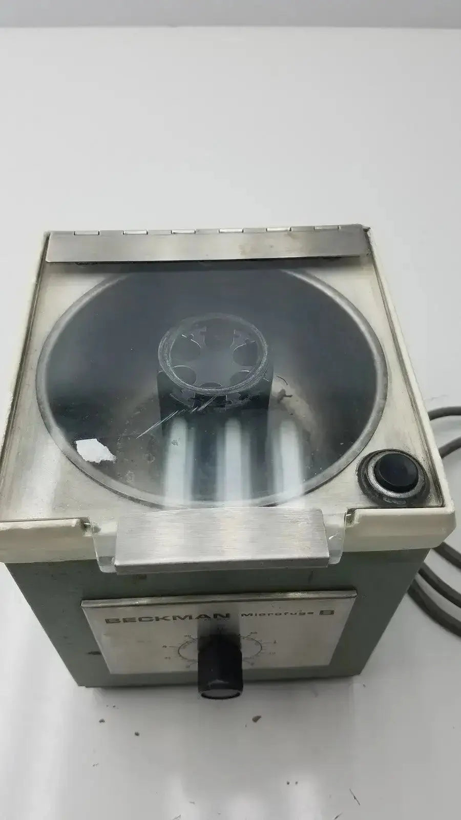 Beckman microfuge microcentrifuge b with stainless steel body, transparent lid, and black control knob for lab use
