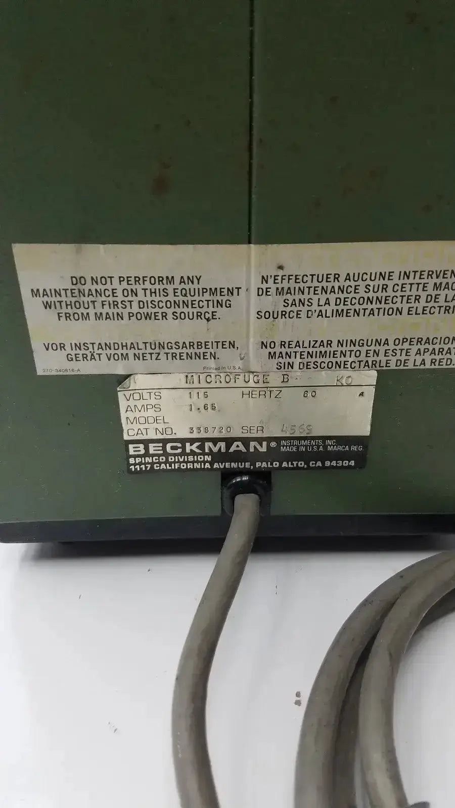 Green beckman microfuge b microcentrifuge with white label showing technical specifications and safety warnings multiple languages