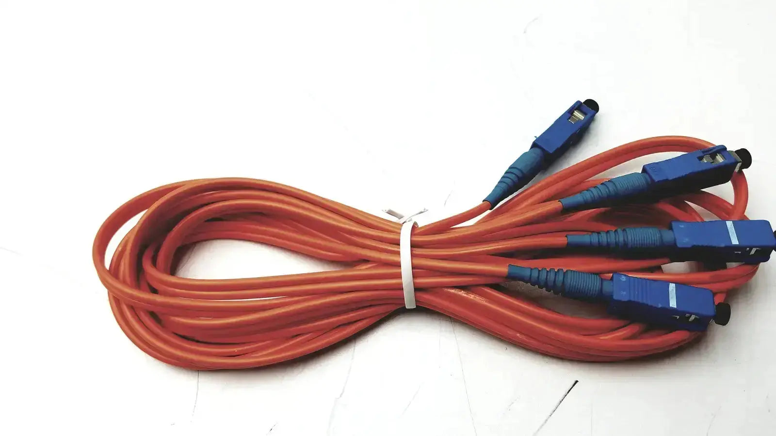 Orange berk-tek optical fiber cable with blue connectors bundled together icr0x0 hospital surplus product