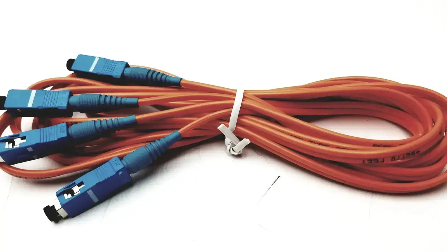 Orange berk-tek optical fiber icr0x0 cables with blue connectors bundled together from hospital surplus stock