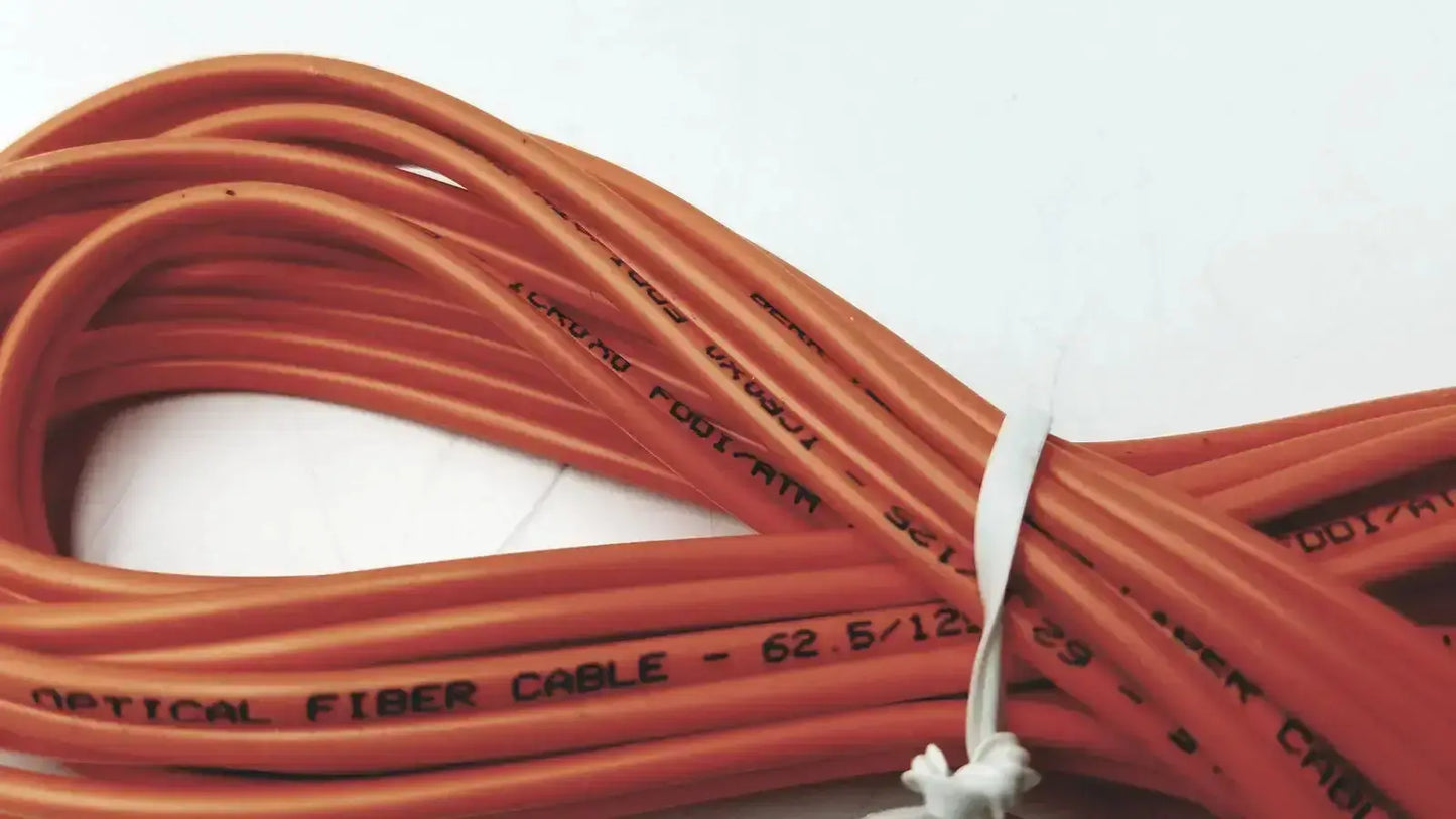 Orange berk-tek optical fiber cable icr0x0 with black text and white tie securing hospital surplus bundle