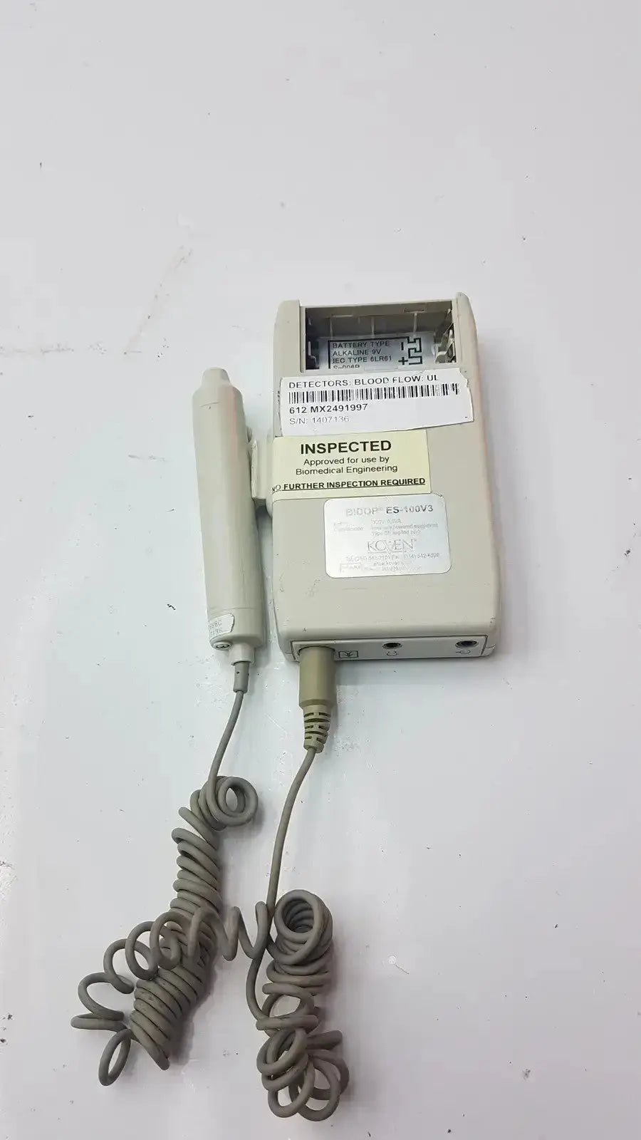 Beige bidop hadeco es-100v3 bi-directional vascular doppler handheld unit with coiled gray cables and inspection labels