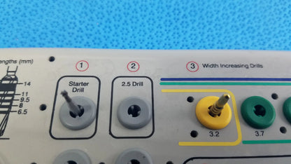 Yellow and green tapered internal dental drill bits with labeled sizes in a gray plastic tray from bio horizons surgical kit