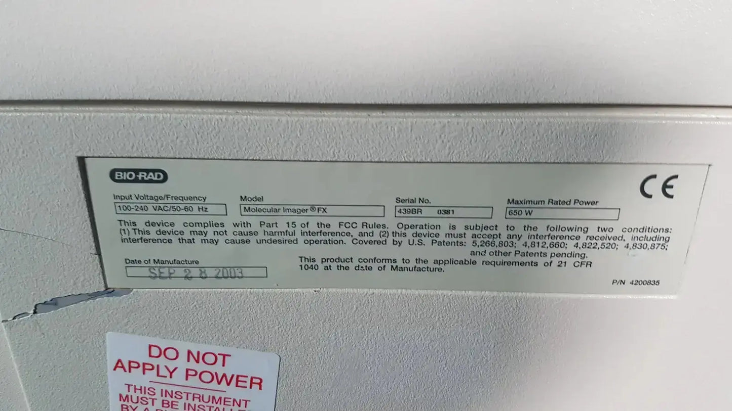 Gray metallic label with black text and ce mark on the back of a bio rad molecular imager fx device showing technical specifications