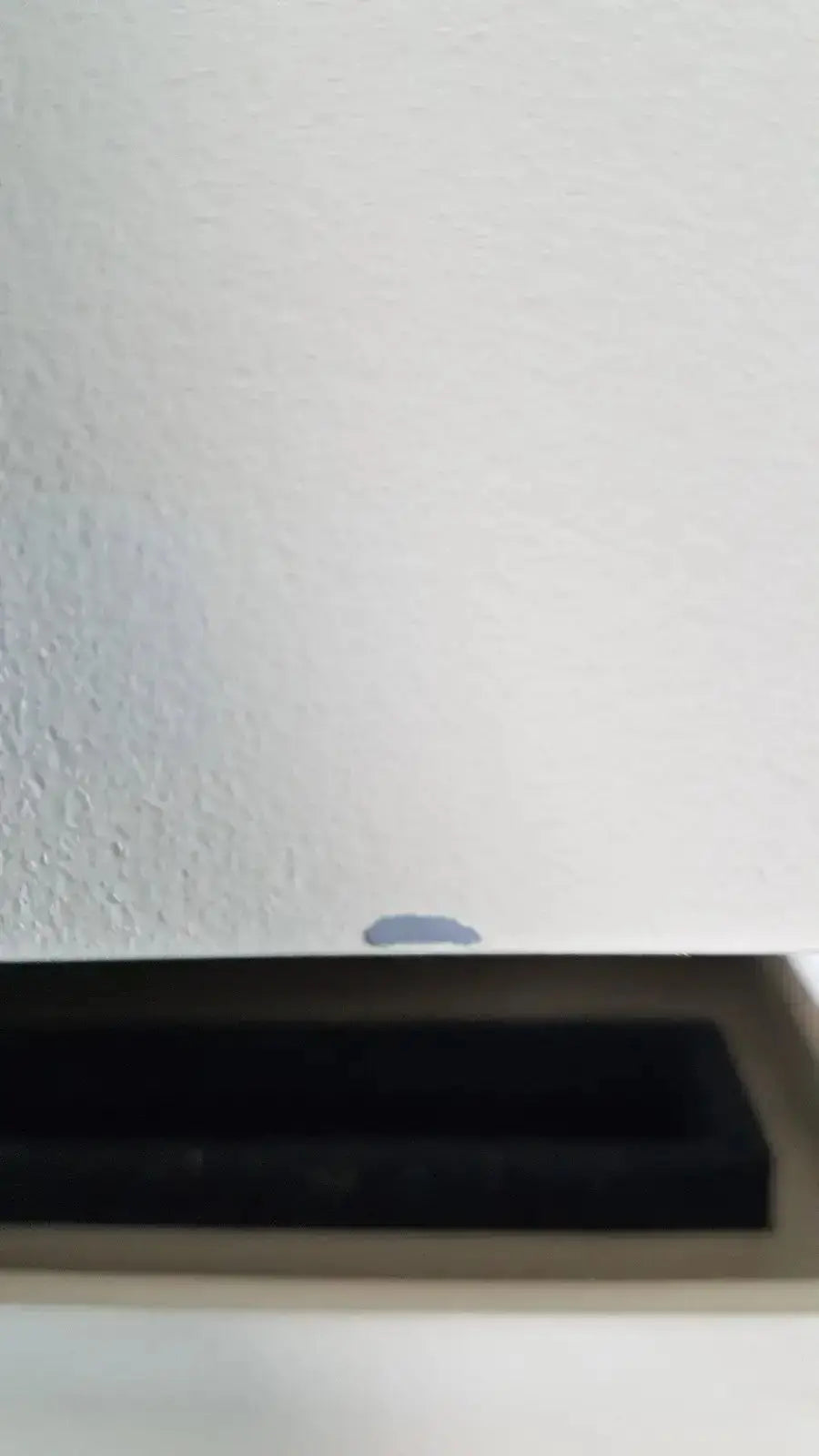 A small dark grayish-blue liquid droplet on a white surface from a bio rad molecular imager fx product image
