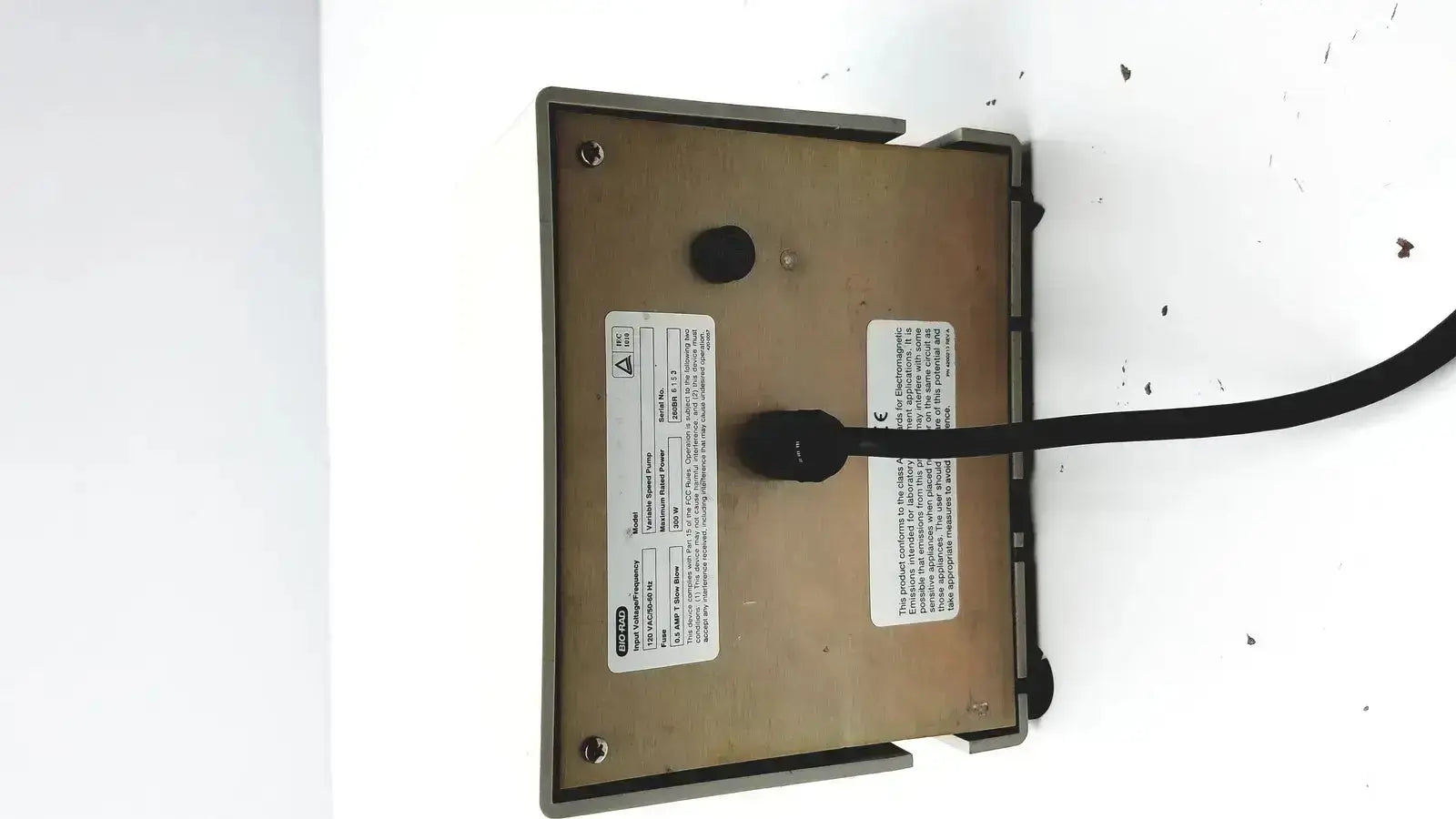 Beige rectangular bio-rad variable speed pump 260-br with black cable and white labels on the back side of the speed pump