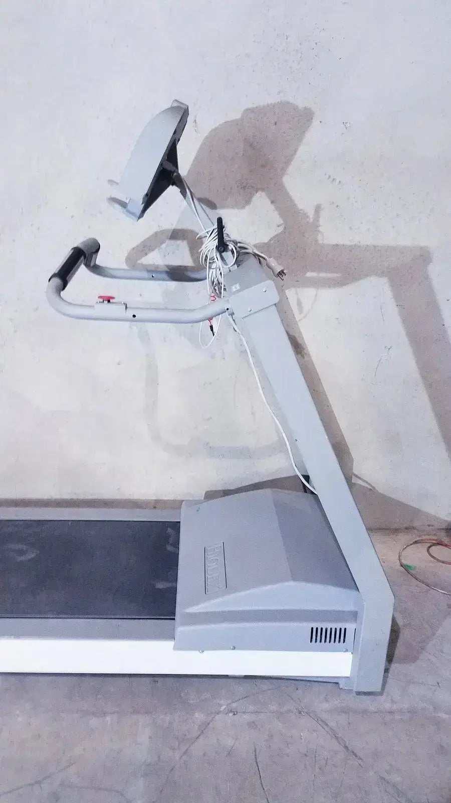Gray plastic and metal biodex gait trainer ii treadmill with digital display screen mounted on handlebars