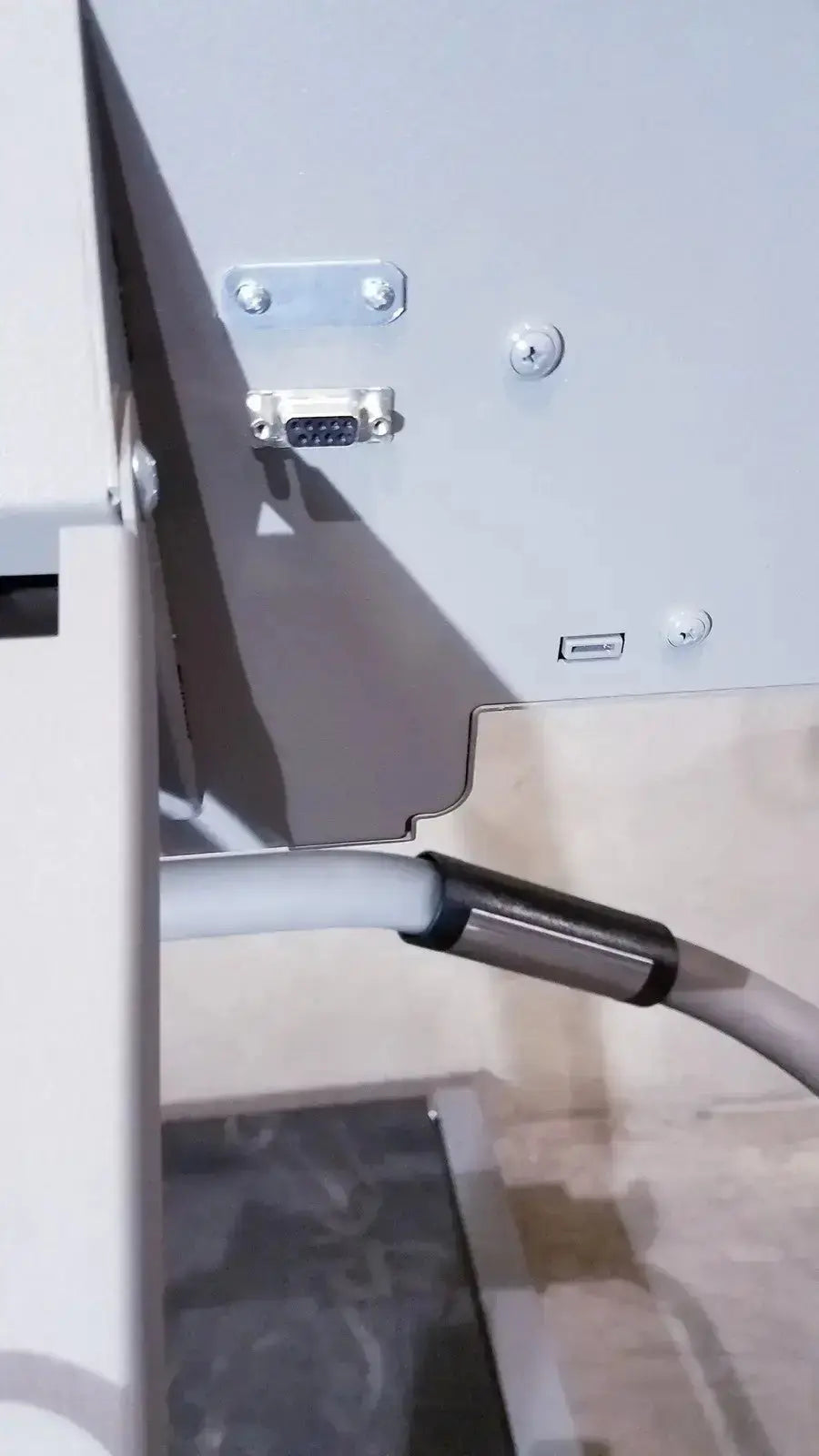 A white cable with a metallic connector for the biodex gait trainer ii treadmill gait trainer device