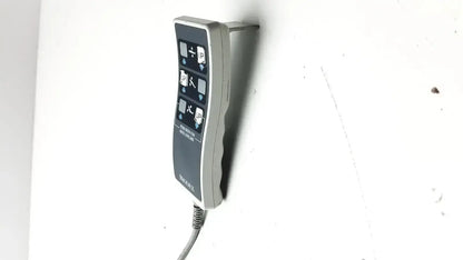 Gray wall-mounted Biodex ultrasound table remote controller with curved ergonomic design and coiled cable attached