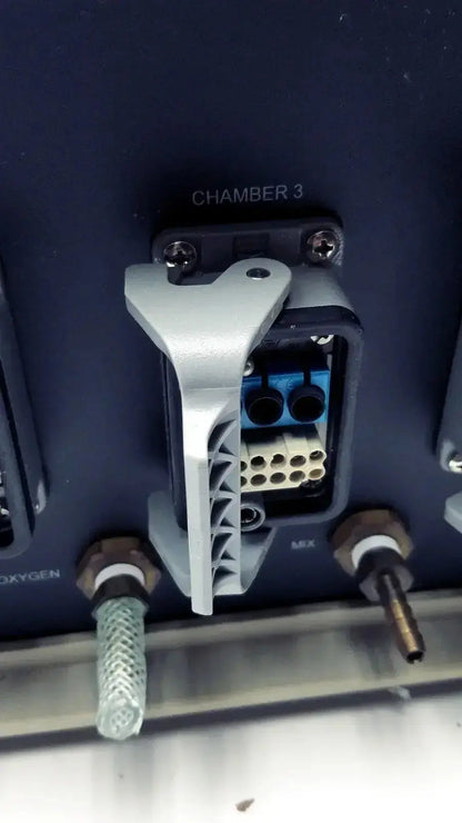 Silver-colored angular plastic latch securing multi-pin connector chamber 3 on biospherix oxycycler a84xov dynamic o2 controller