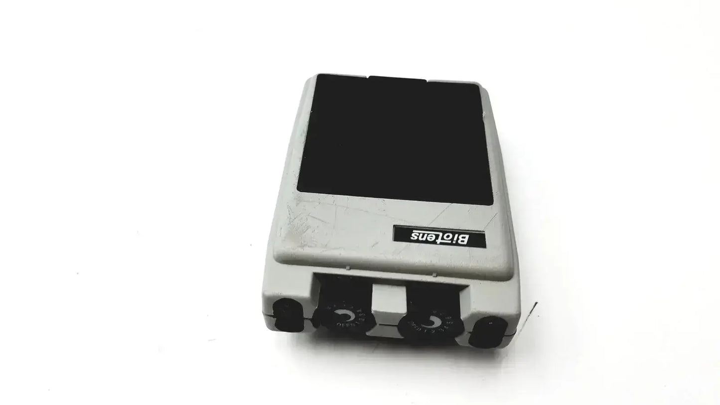 Gray plastic biotens transcutaneous electrical nerve stimulator with black top panel and circular front dials