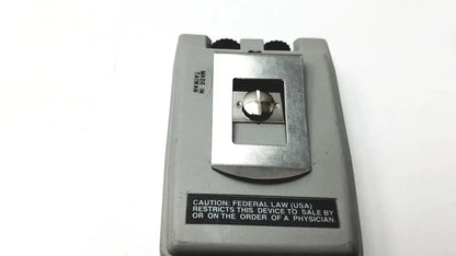Gray plastic handheld biotens transcutaneous electrical nerve stimulator with metallic silver button insert