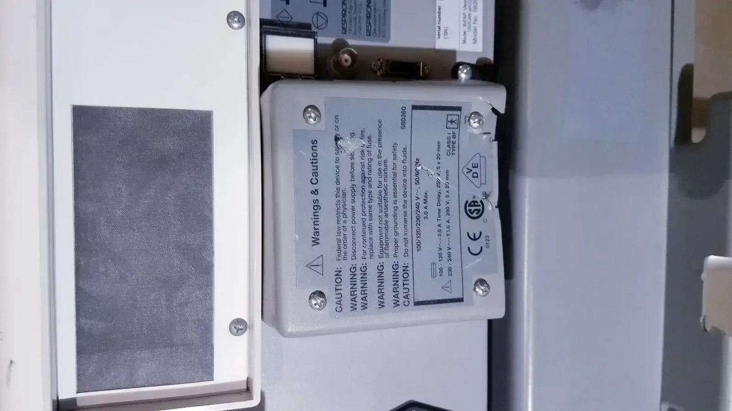 White rectangular electronic component with printed warnings on the back of bipap vision ventilatory support system 582059 with stand