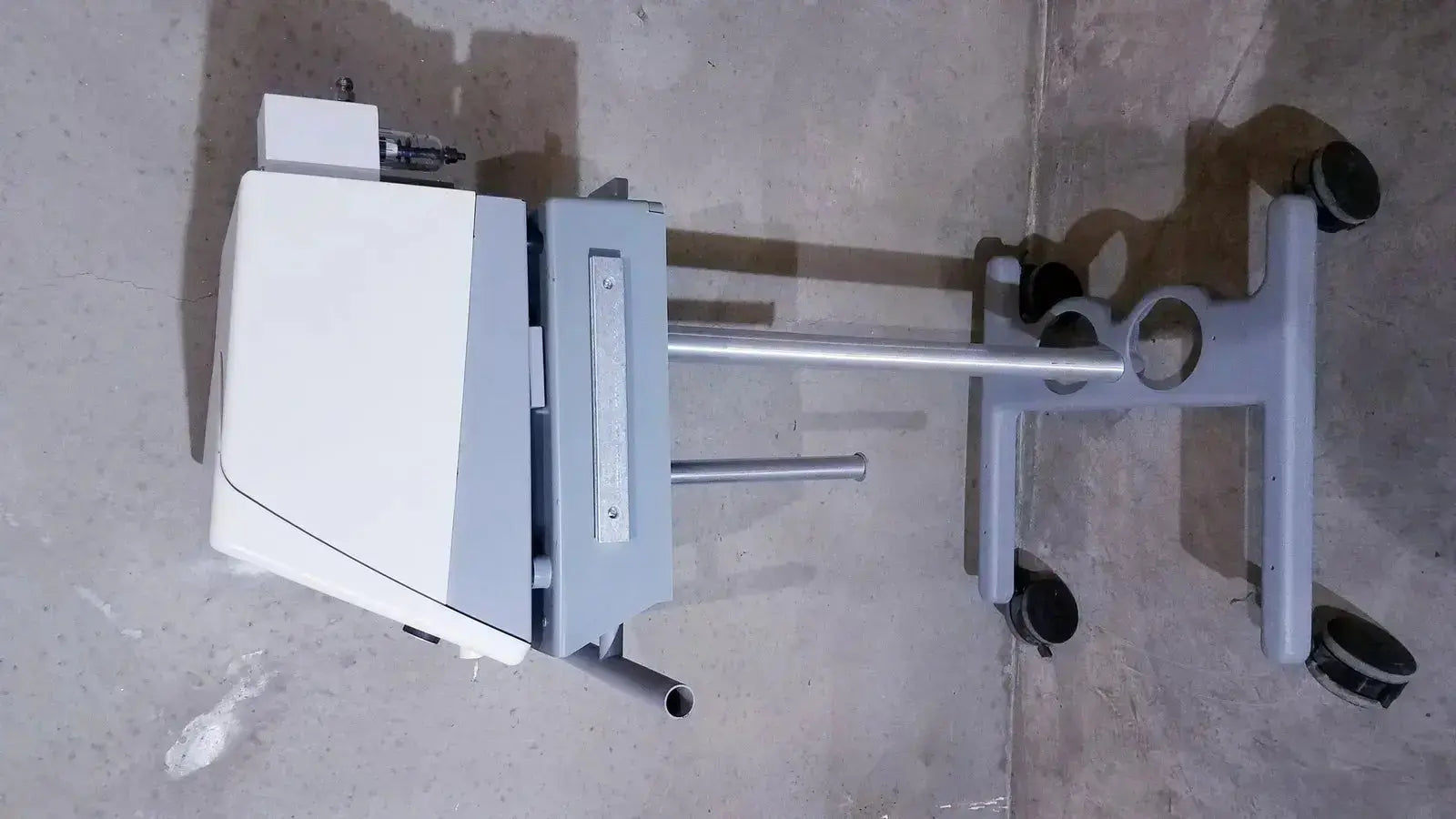 Gray medical cart with bipap vision ventilatory support system mounted on white and gray stand with four black caster wheels