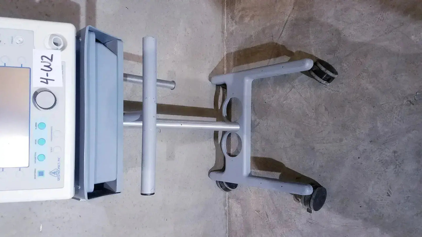 Gray bipap vision ventilatory support system 582059 medical cart with white control panel and four black wheels on stand