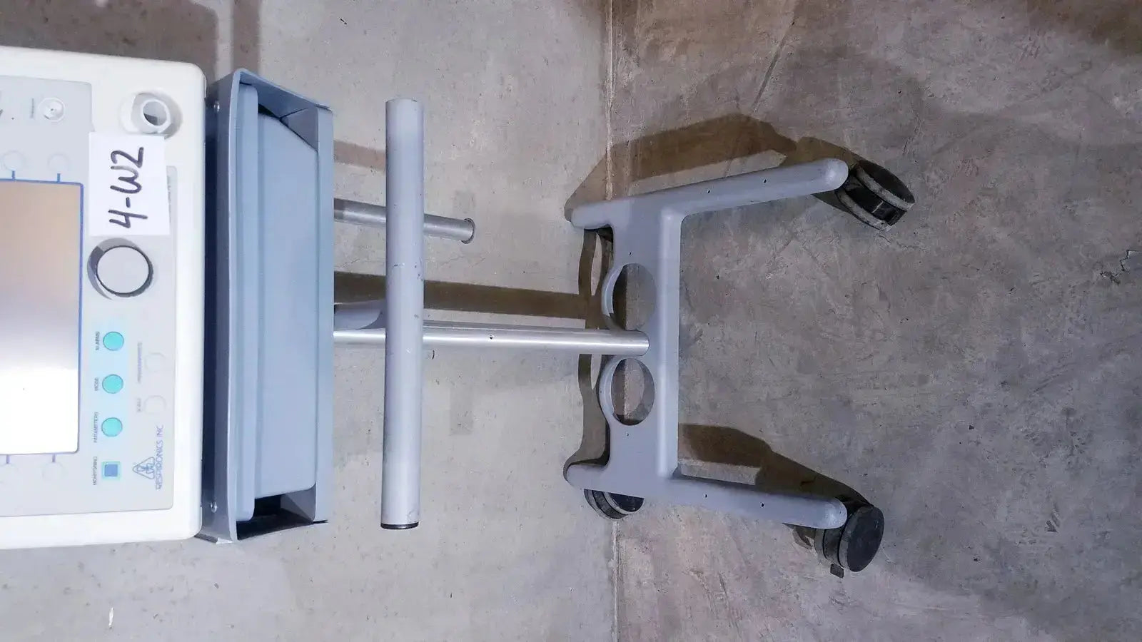 Gray bipap vision ventilatory support system 582059 medical cart with white control panel and four black wheels on stand
