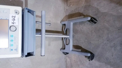 Gray bipap vision ventilatory support system 582059 medical cart with white control panel and four black wheels on stand