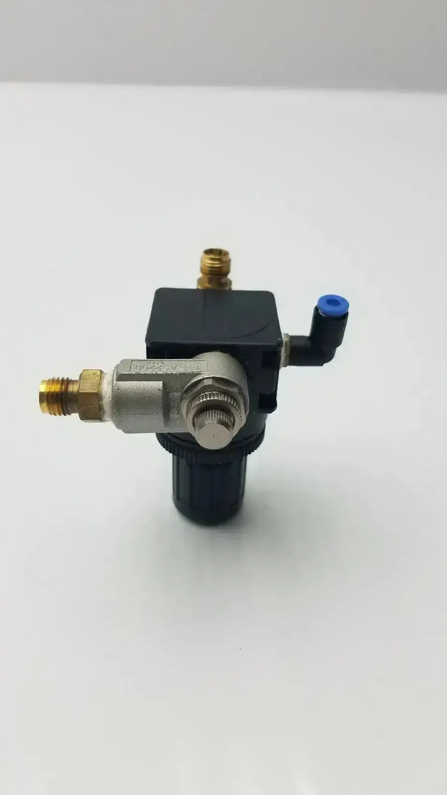 Black and silver bosch pressure reducer throttle valve with brass fittings and blue cap for air pressure control