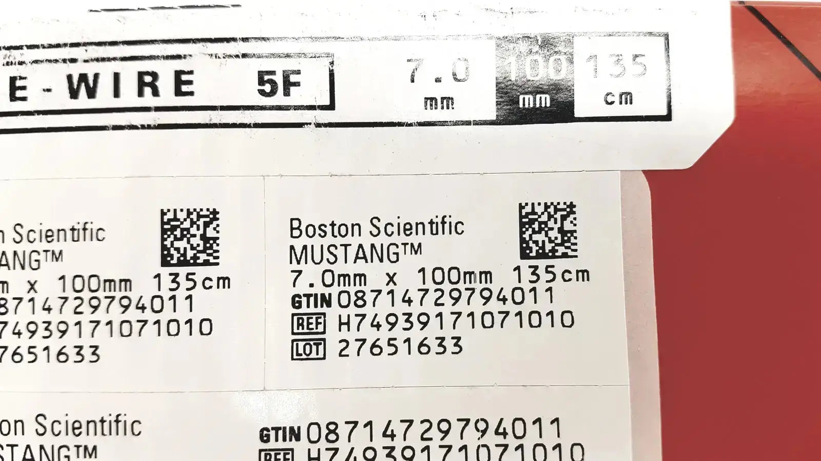 Boston scientific mustang otw medical wire 7.0mm x 100mm with label and barcode on white against red background