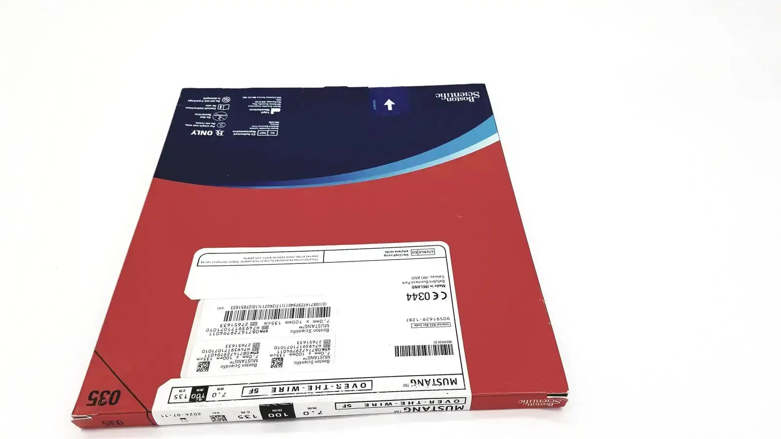 Red and blue cardboard package of boston scientific mustang otw abrasive paper for over the wire 12mm x 60mm use