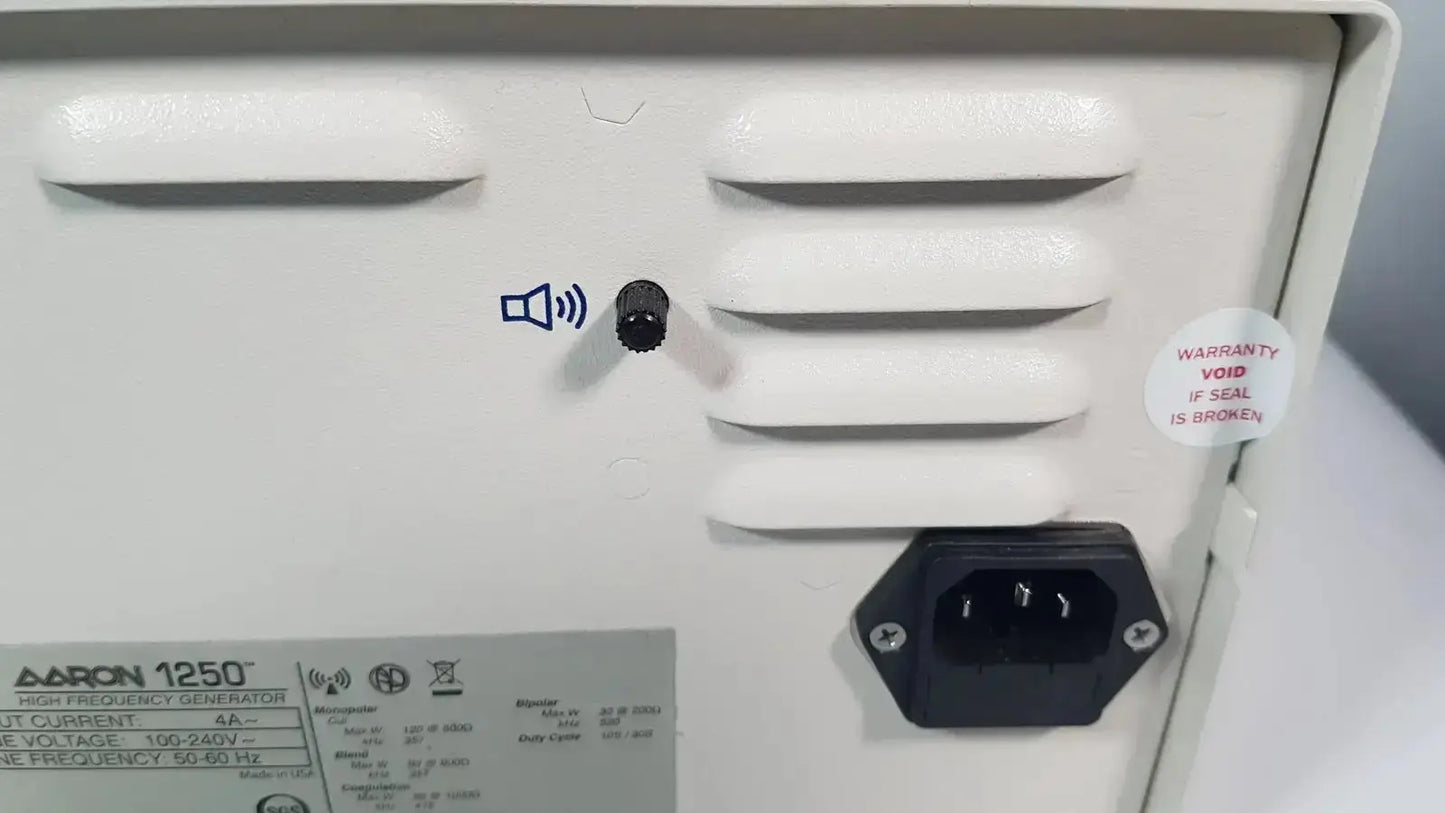 White plastic back panel of bovie aaron 1250 electrosurgical generator with ventilation slats and power input socket hospital surplus