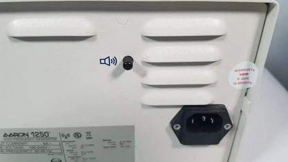 White plastic back panel of bovie aaron 1250 electrosurgical generator with ventilation slats and power input socket hospital surplus