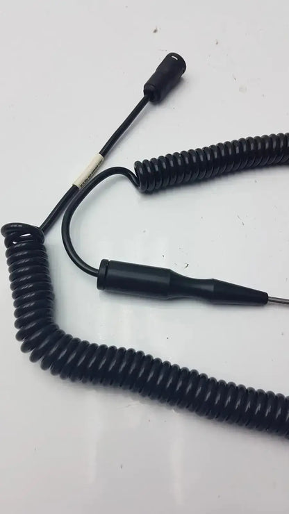 Black coiled thermometer probe cable with cylindrical connector and pointed probe for hospital surplus biomedical technicians