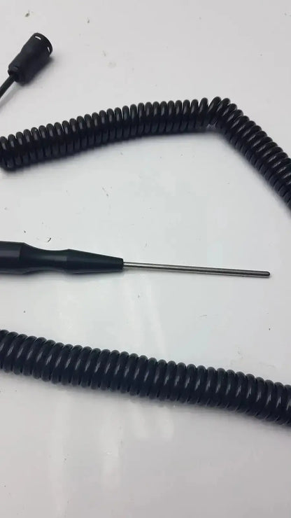 Black coiled thermometer probe with metallic tip and connector end for biomedical technicians from hospital surplus