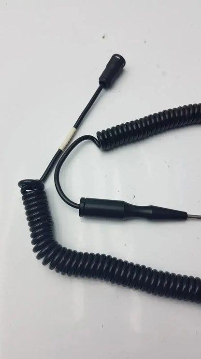 Black coiled thermometer probe cable with two black connectors including one metallic tip for hospital surplus use
