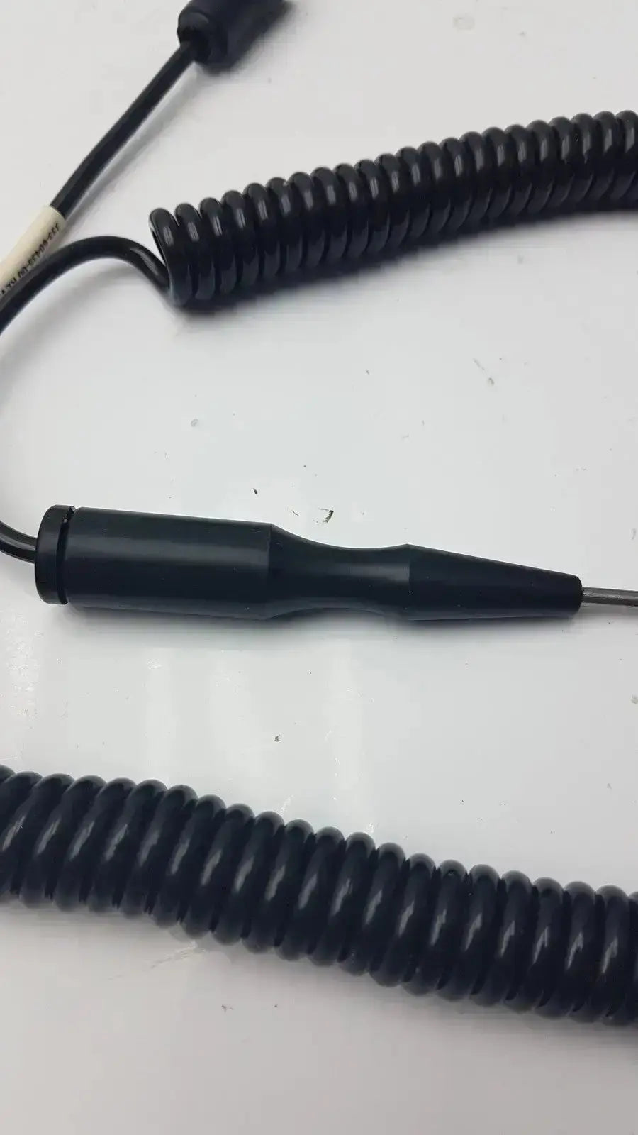 Black coiled cable thermometer probe with matte cylindrical probe attachment for hospital surplus biomedical technicians