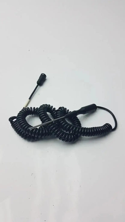 Black coiled thermometer probe with thin metal tip and two black plastic handles for biomedical technicians hospital surplus use