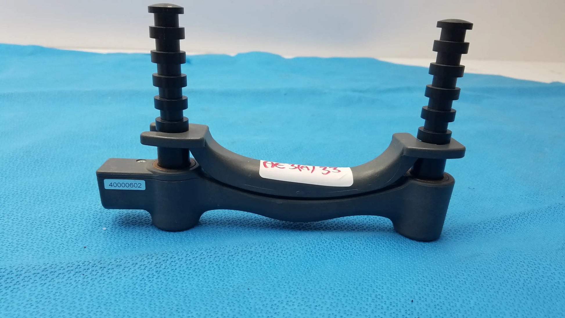 Black plastic brake caliper bracket with threaded adjustment rods for bte technology hydraulic hand dynamometer