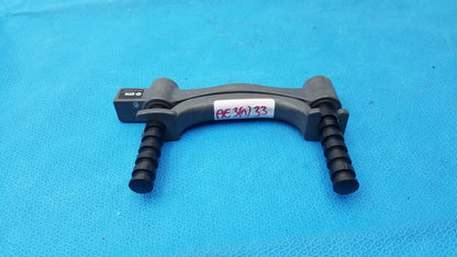 Black plastic hydraulic hand dynamometer with textured grip handles and small label on top for precise measurement
