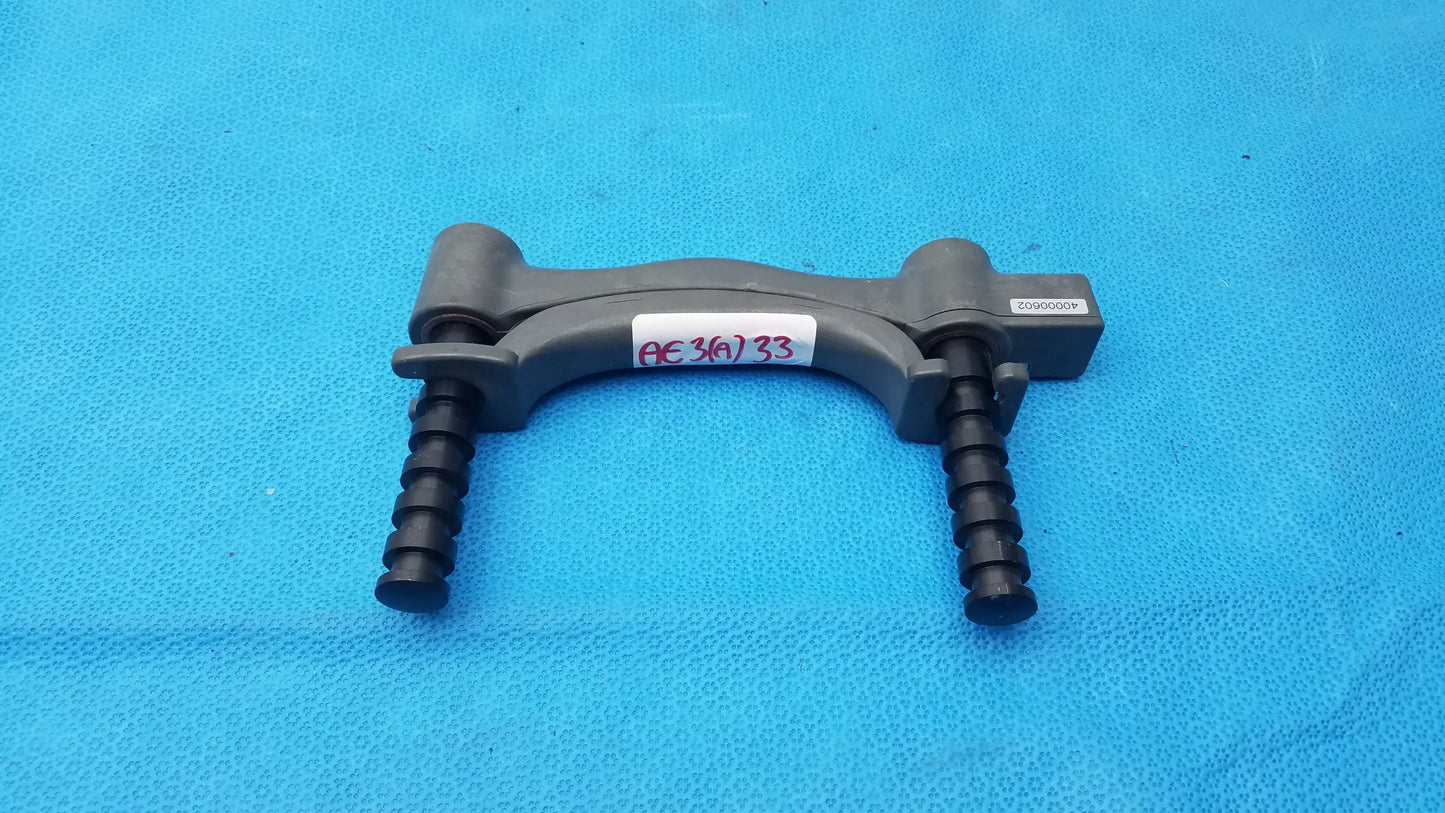 Gray plastic dental handpiece clamp with black threaded adjustment arms for bte technology hydraulic hand dynamometer