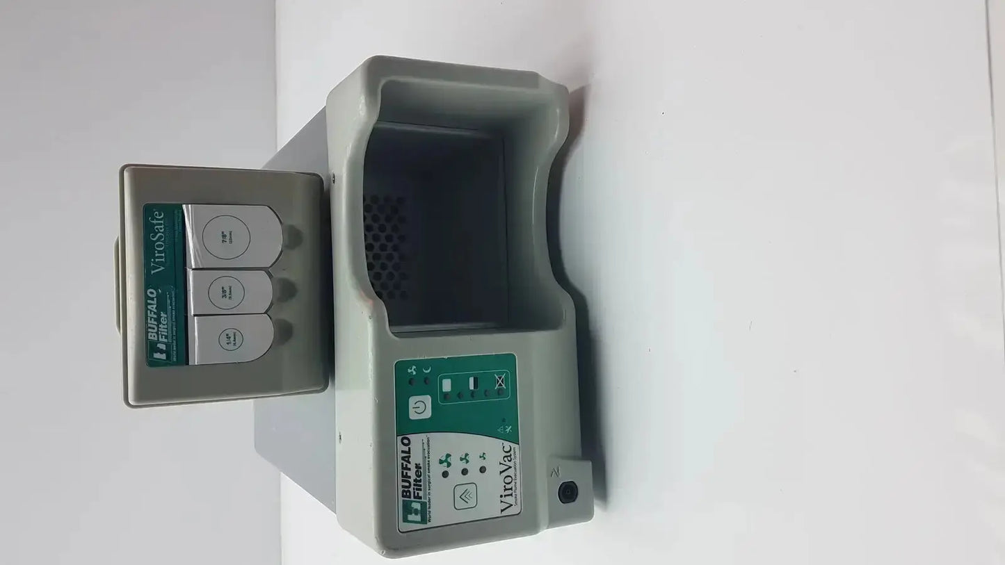 Gray plastic buffalo filter virovac smoke evacuation device with green labeling and three circular buttons on left unit