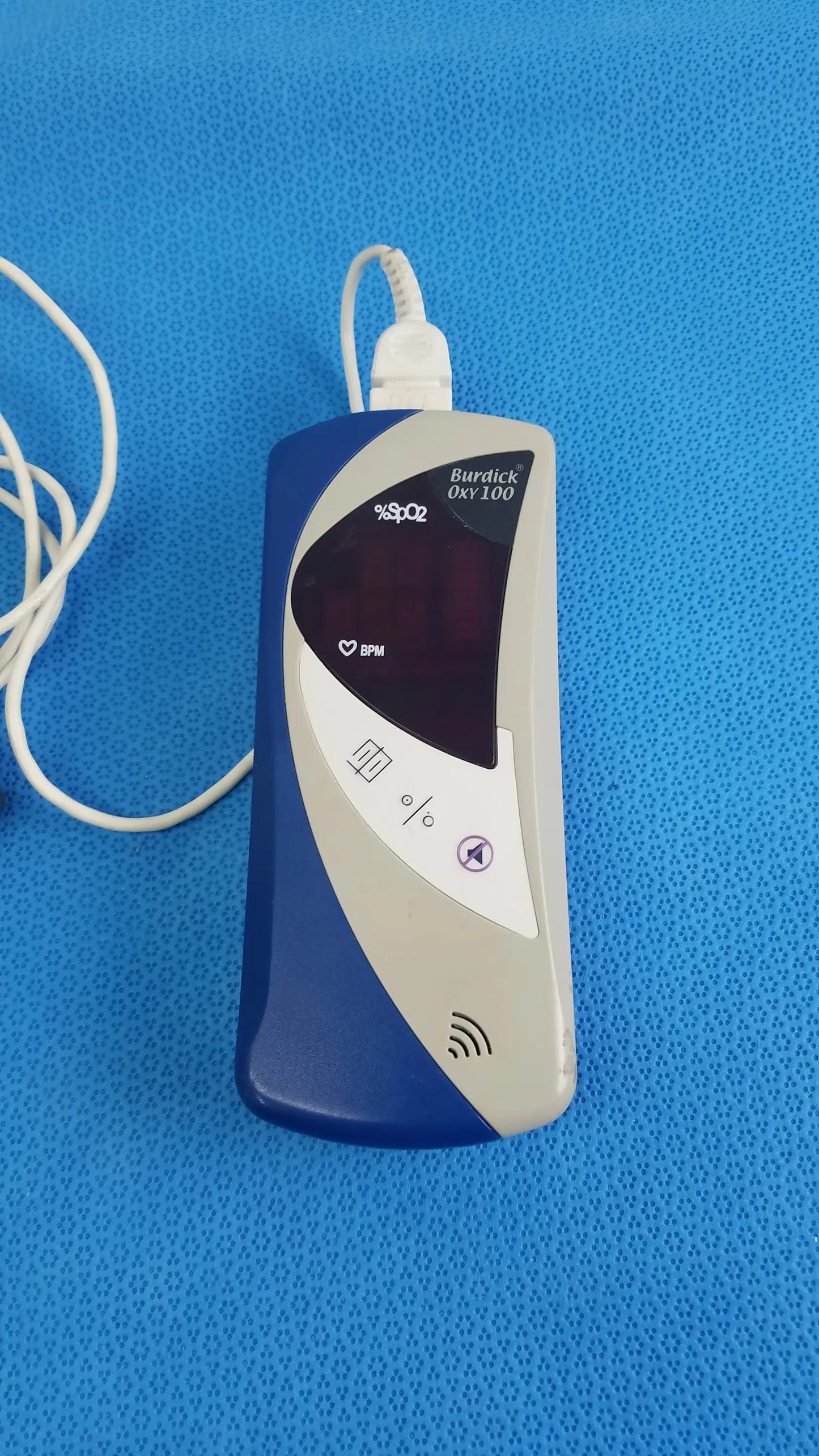 Blue and silver Burdick OXY 100 pulse oximeter ref 92521 with white cable for reuse medical equipment monitoring