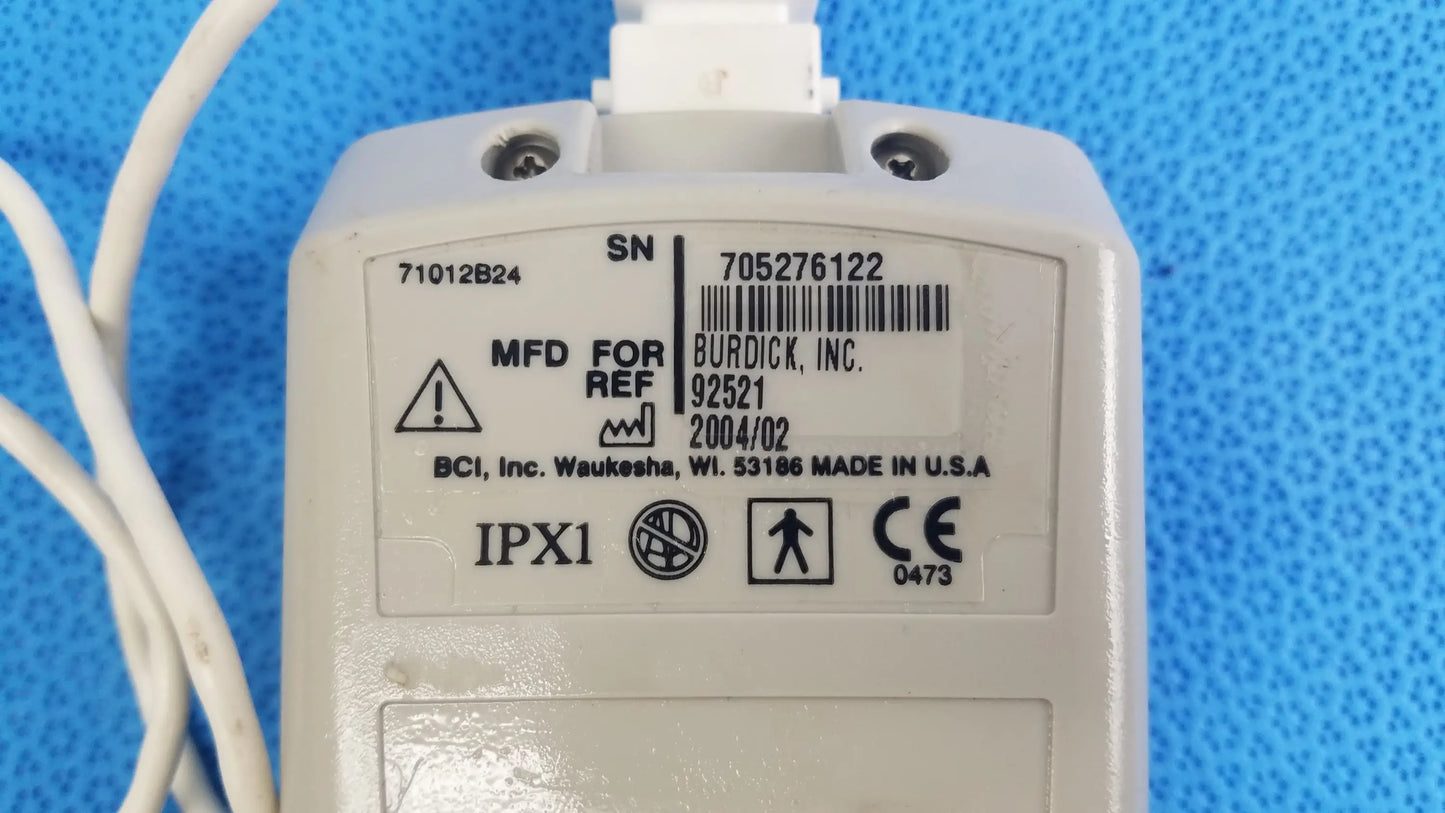 White plastic Burdick OXY 100 pulse oximeter ref 92521 with barcode label and regulatory markings for medical equipment reuse