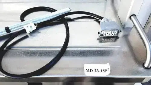 Black coiled cable with silver metallic connector labeled md-23-1557 for burlodge multigen ii blm52 returned items